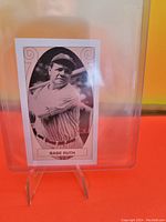 Photo of 1991-92 #1 Babe Ruth sports card from Allan Kaye's Sports Cards News Magazine, showing black and white image of Babe Ruth in baseball uniform inside clear protective case with stand.