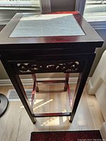 Full view of the Chinese rosewood side table showing the marble top and carved apron.