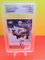 Front of Jake Neighbours graded rookie card #25 showing player in St. Louis Blues uniform skating on ice.