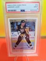 Front of the 1990 O-Pee-Chee Premier Jaromir Jagr hockey card graded PSA 9 in clear slab with player in Penguins uniform.