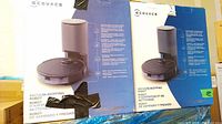 Two unopened Ecovacs Deebot N8 Pro+ Vacuum + Mopping Robot boxes, each displaying the robot with its auto-empty station