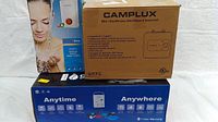 Three packaging boxes side by side: white Flow instant heater, Camplux mini-tank, blue propane tankless box