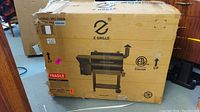 Cardboard shipping box printed with Z Grills logo, model ZPG-7002B, ETL Intertek mark and fragile label