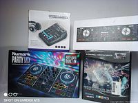 Four original retail boxes of DJ gear arranged on table