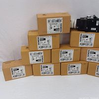 Multiple Siemens QF260ACSA 60A GFCI breakers in OEM boxes arranged in stacked formation.