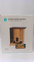 Retail packaging front showing Birdfy logo, product name “Birdfy Feeder Bamboo Smart Bird Feeder with FHD Camera” and image of feeder with camera.