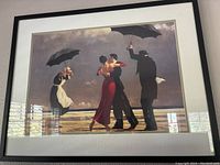 Front-facing photo of framed print showing couples dancing on beach with umbrellas.