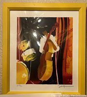 Signed lithograph print by Emile Bellet depicting jazz instruments, framed in yellow.