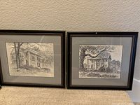 Two framed line drawings of classical houses, featuring columns and trees, with light grey mats and black frames