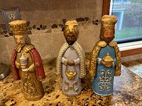 Front view of three Three Wise Men figurines showing detailed paint and attire on kitchen counter.