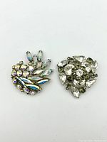 Both Sherman signed brooches shown side by side, colorful and clear rhinestone designs.