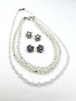 Full lot displayed including two pairs of clip-on earrings and two crystal necklaces.