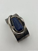 Front angle of the silver cuff bracelet showing sodalite stone and metal framing.