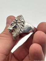Front side view of the lion head ring on finger showing detailed lion face and mane.