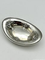 Top angled photo showing size and ornate floral design with beaded edge