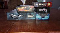 Stacked boxes showing titles The Forgotten Planet, The Lords of Rock, Honor of the Samurai, and MindTrap