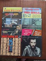 Photo showing front covers of 10 country vinyl albums, featuring artists Hank Williams, Wilf Carter, Eddy Arnold, Lee Greenwood, and others.