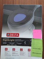 Front photo of the unopened box showing image of the product installed on a toilet with purple nightlight glow, brand and product name