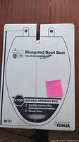 Front of box showing Kohler elongated bowl toilet seat labeling, size indication and unopened status.