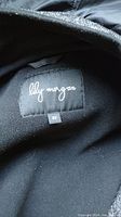 Photo of the coat's brand label showing 'lily morgan' and size 2X on a black fabric tag.