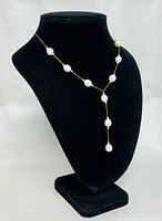 Full view of pearl Y-drop necklace on black display bust
