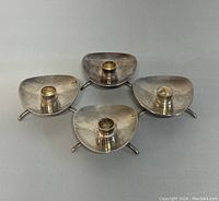 Four silver plated triangular candle stick holders by Cohr, Atla, arranged close together to show overall condition and design