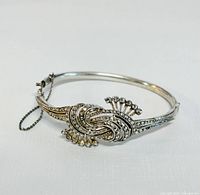 Front view of the intricately designed silver bracelet showing marcasite stones and knot motif.