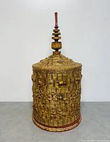 Front view of ornate gold lacquer exterior with lid in place