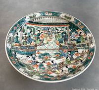 Top view of the porcelain dish showing the full painted scene and rim decoration.
