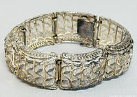 Close-up view of bracelet showing intricate woven and textured sterling silver design and clasp.
