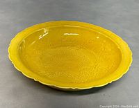 Front view of yellow glazed plate showing dragon motif