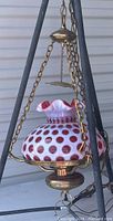 Full view of Fenton hanging lamp with cranberry coin dot glass shade and brass chain hardware, showing entire lamp suspended.