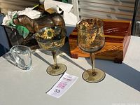 Lot items arranged together: two Venetian glasses, carved wooden dog, small clear vase, and wooden box
