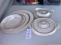 Set of Royal Doulton Fairfax serving pieces displayed on table with lot tag.
