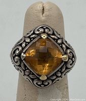 Front view showing square cushion-cut citrine stone with checkerboard faceting and intricate sterling silver scrollwork.