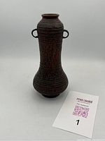 Full view of bronze vase, showing overall shape and texture