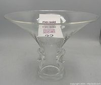 Full front view of the clear glass vase with flared wide opening, showing its shape and decorative features on the stem.