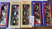 Five boxes of vintage glass Christmas ornaments, each with 3 ornaments inside except one missing one ornament, total 14 ornaments with multicolored patchwork design.