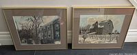 Two framed prints by Ben Babelowsky depicting Mackenzie House and Winter in Niagara Wine Country, resting side by side against a wall.