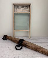 Washboard and wooden ox yoke laid flat showing entire washboard and length of yoke with iron hardware clearly visible.
