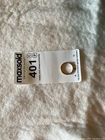 Ring placed on a MaxSold tag showing top view of the band