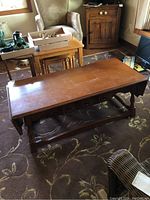 Maple wood drop leaf coffee table by Vilas seen from above showing scuffed top surface and overall wear.