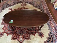 Top view of oval wooden coffee table showing surface wear and scratches.