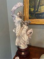 Full frontal view of the Lladro Allegory of Liberty figurine on wooden base