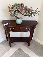 Front view of demi-lune entry table with faux bonsai on top