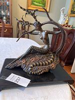 Overall front view of the Erté 'Hunting' bronze sculpture on a rectangular black base.