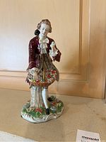 Front view of the full figurine showing posture and attire