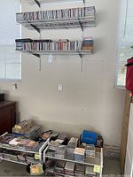 Wall-mounted shelving with rows of audio CDs in jewel cases