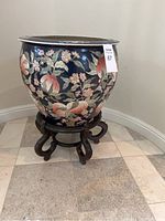 Front view of planter on stand showing peach blossom motif