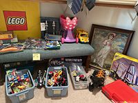 Overview of bench seat, jewelry stand, ride-on toys, panels of loose LEGO bins